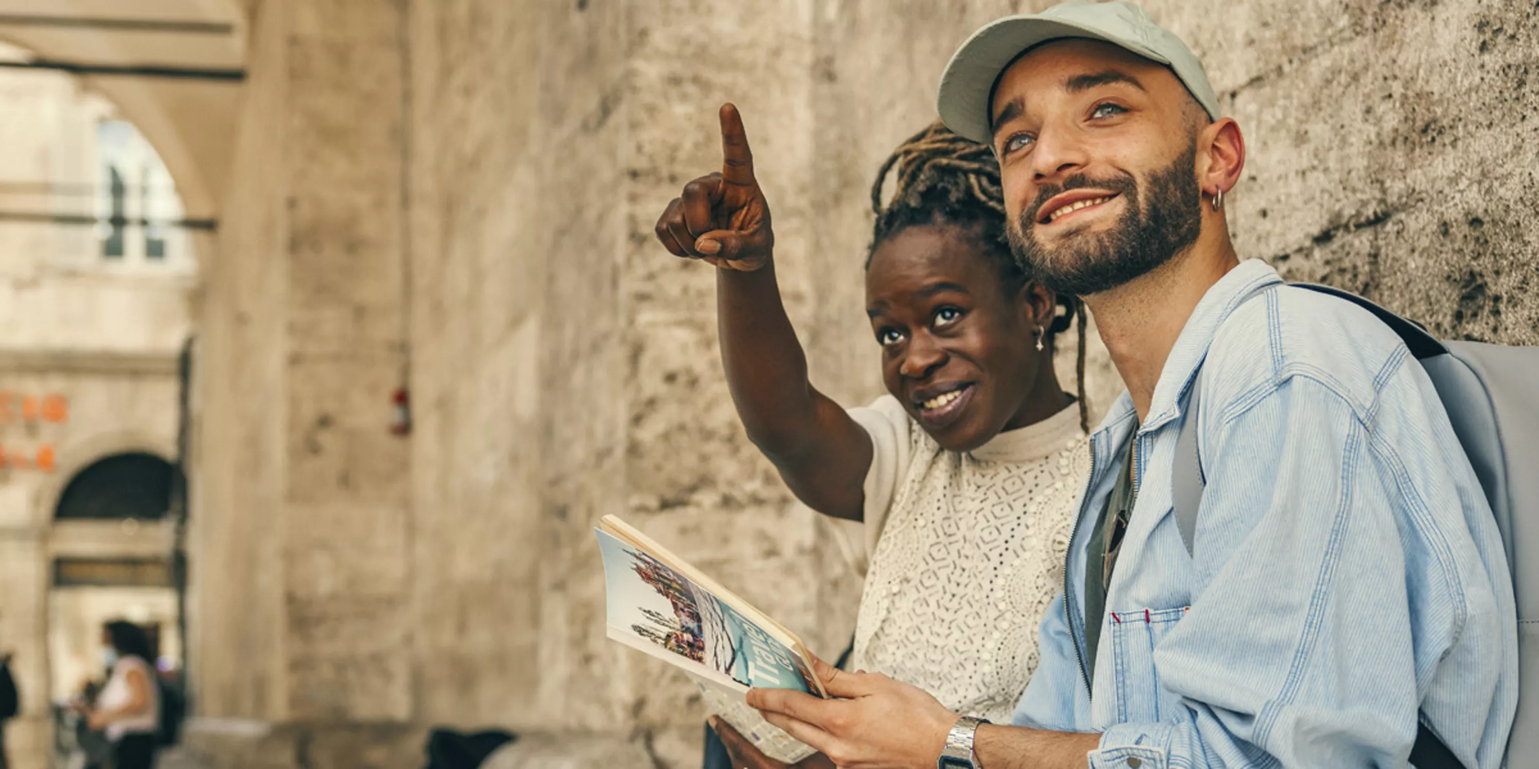 Uśmiechnięta para zwiedza zabytkowe miasto.