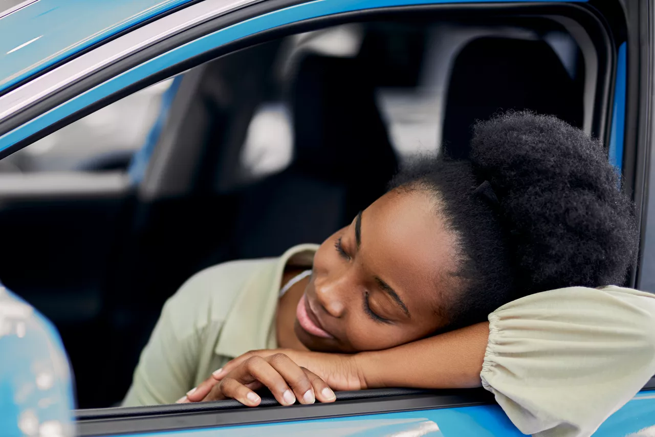 Happy woman in blue car