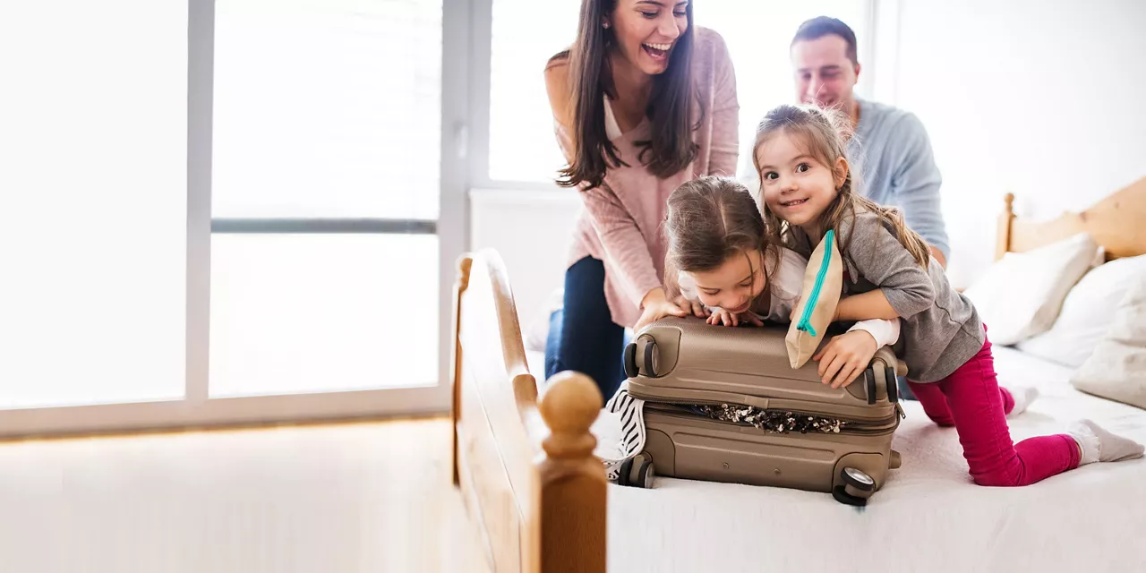 Familie packt gemeinsam einen Koffer