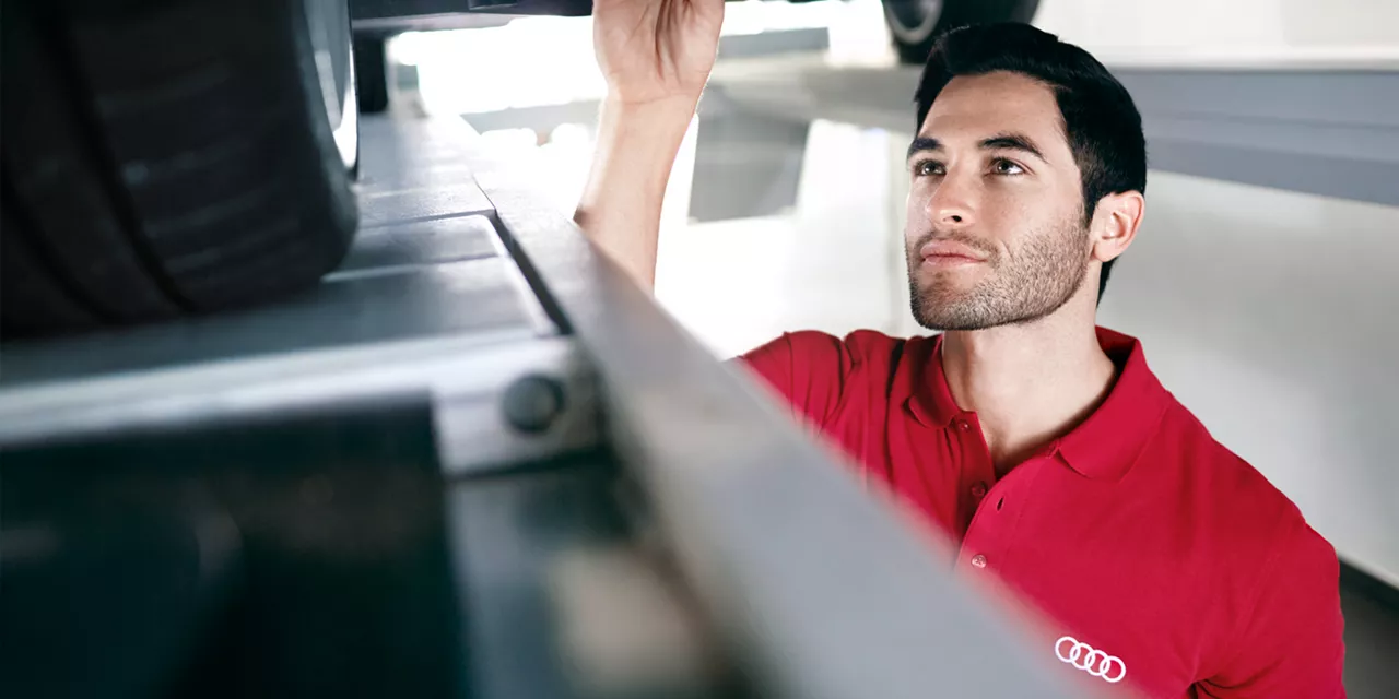 Mechanic servicing and audi car