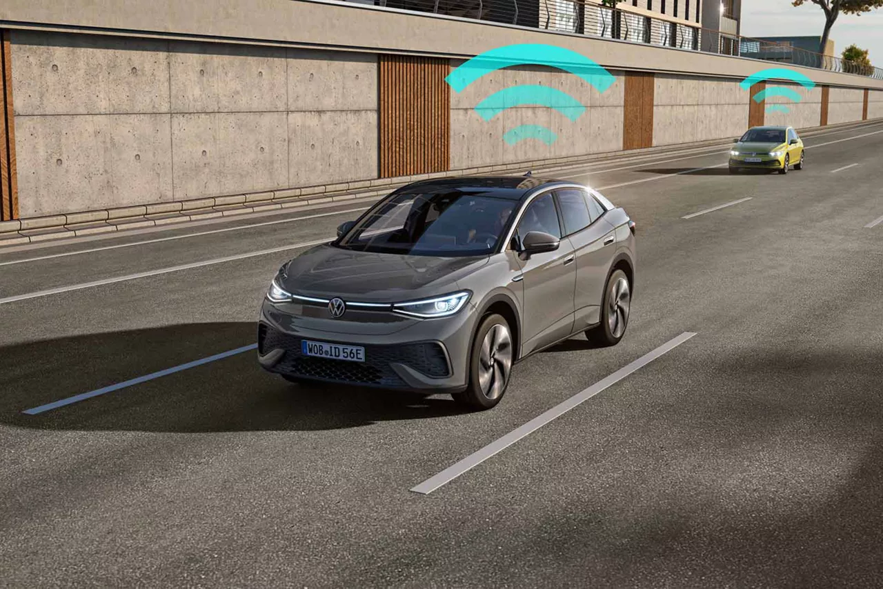 Graues VW ID.5 fährt auf mehrspuriger Straße, Darstellung von Fahrzeug‑zu‑Fahrzeug‑Kommunikation