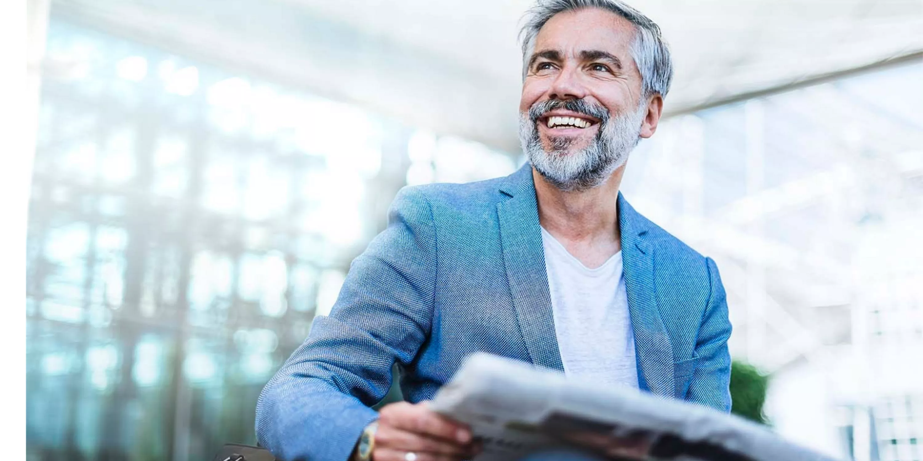 Laughing man with newspaper