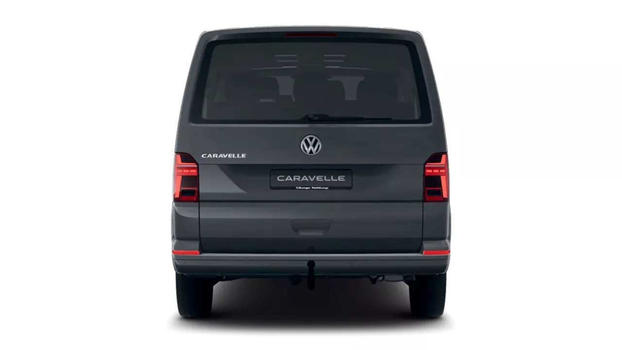 Heckansicht eines dunkelgrauen VW Caravelle vor weißem Hintergrund